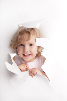 Child peeking through paper